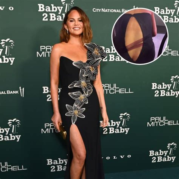Chrissy Teigen Risks Wardrobe Malfunction In Plunging One-Piece Bathing Suit